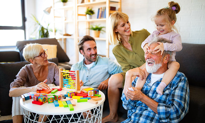 Little girl playing with her parents and grandparents